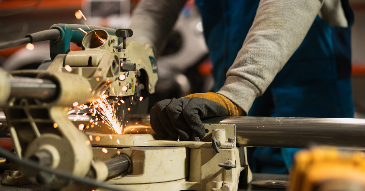 Worker working with a circular grinder on a metal with sparks Technician worker cutting metal with many sharp sparks. Using equipments to cat iron