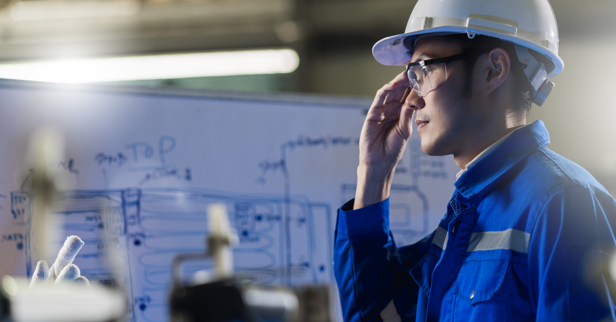 Male Asian engineer professional  having a discussion standing by the machine in the factory ,two asian coworker brainstorm explaining and solves the process curcuit mother board of the machine
