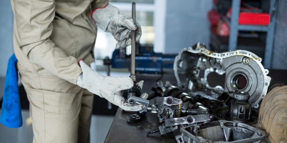 Mechanic checking a car parts in repair shop